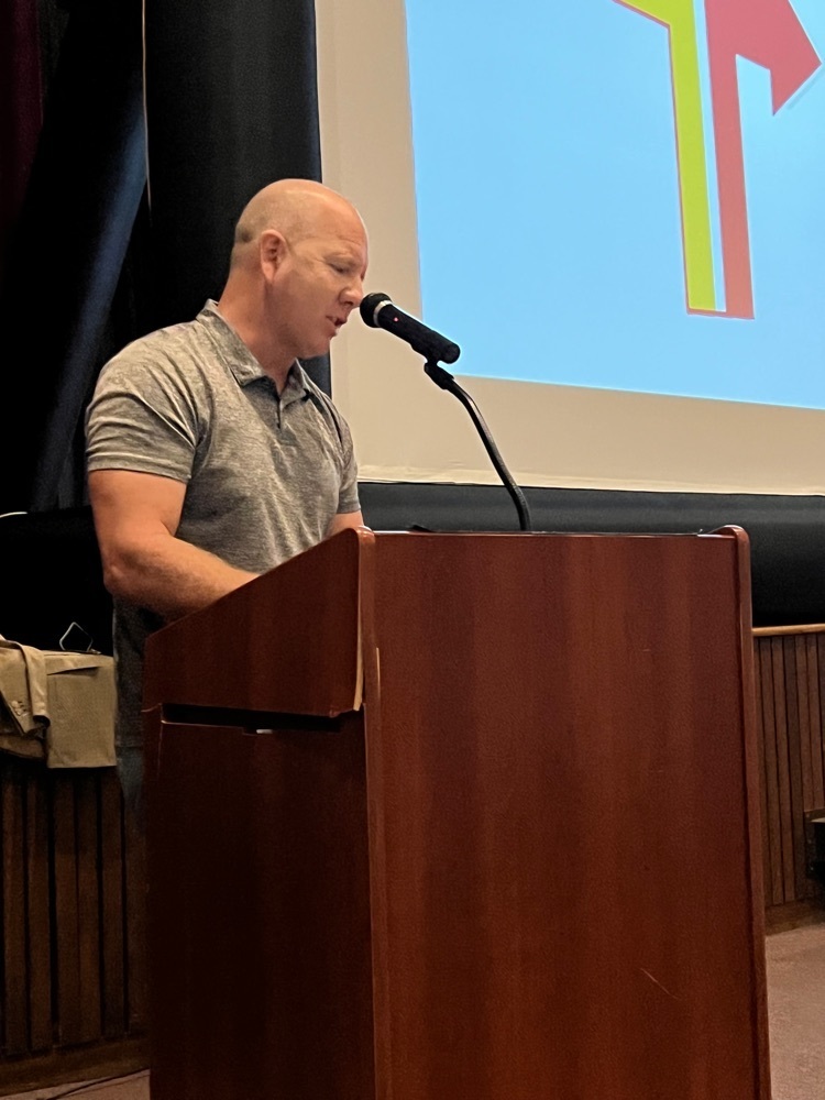 Mr. McGuire standing at podium