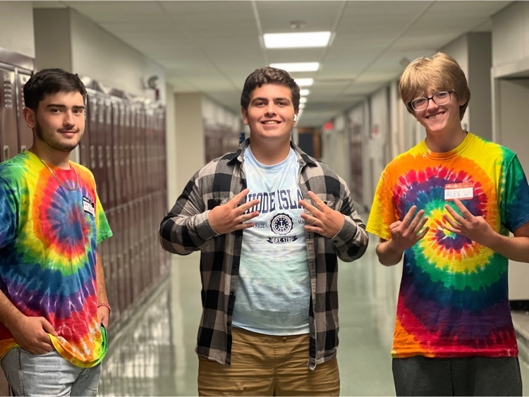3 young men in tie-dye shirts