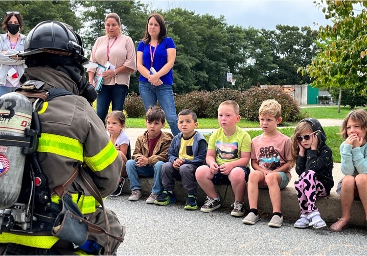 fire fighter talking to children